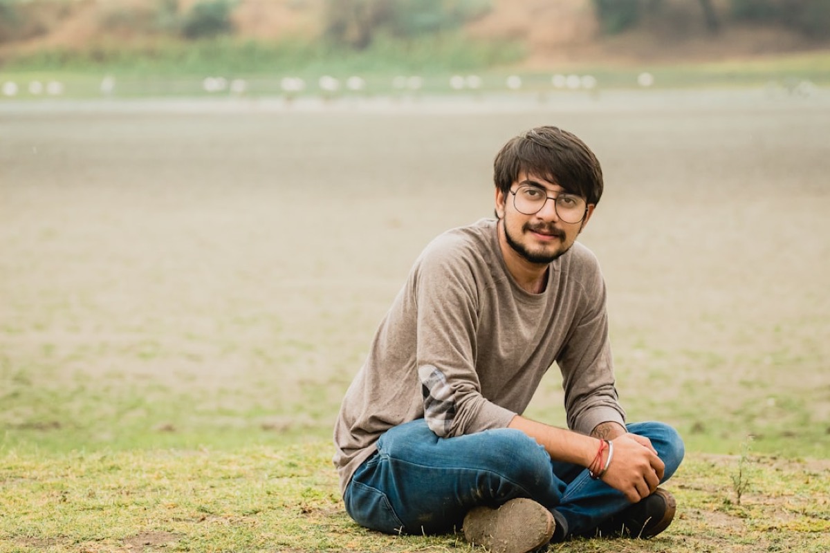 Young man sitting cross-legged, relaxed and at ease